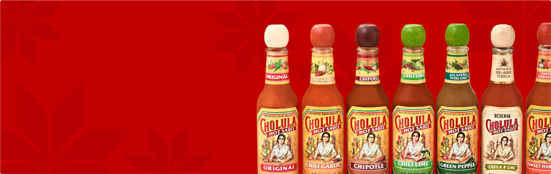 Row of Cholula hot sauce bottles on a red background