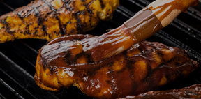 brushing ribs with bbq sauce