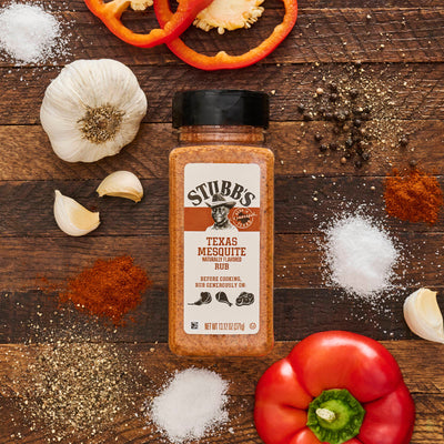 Stubbs texas mesquite on cutting board with spices around it