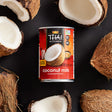 thai kitchen coconut milk can with coconuts around it