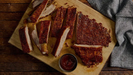 BBQ pork ribs with sauce on cutting board