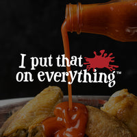 Frank's RedHot pouring on chicken wings