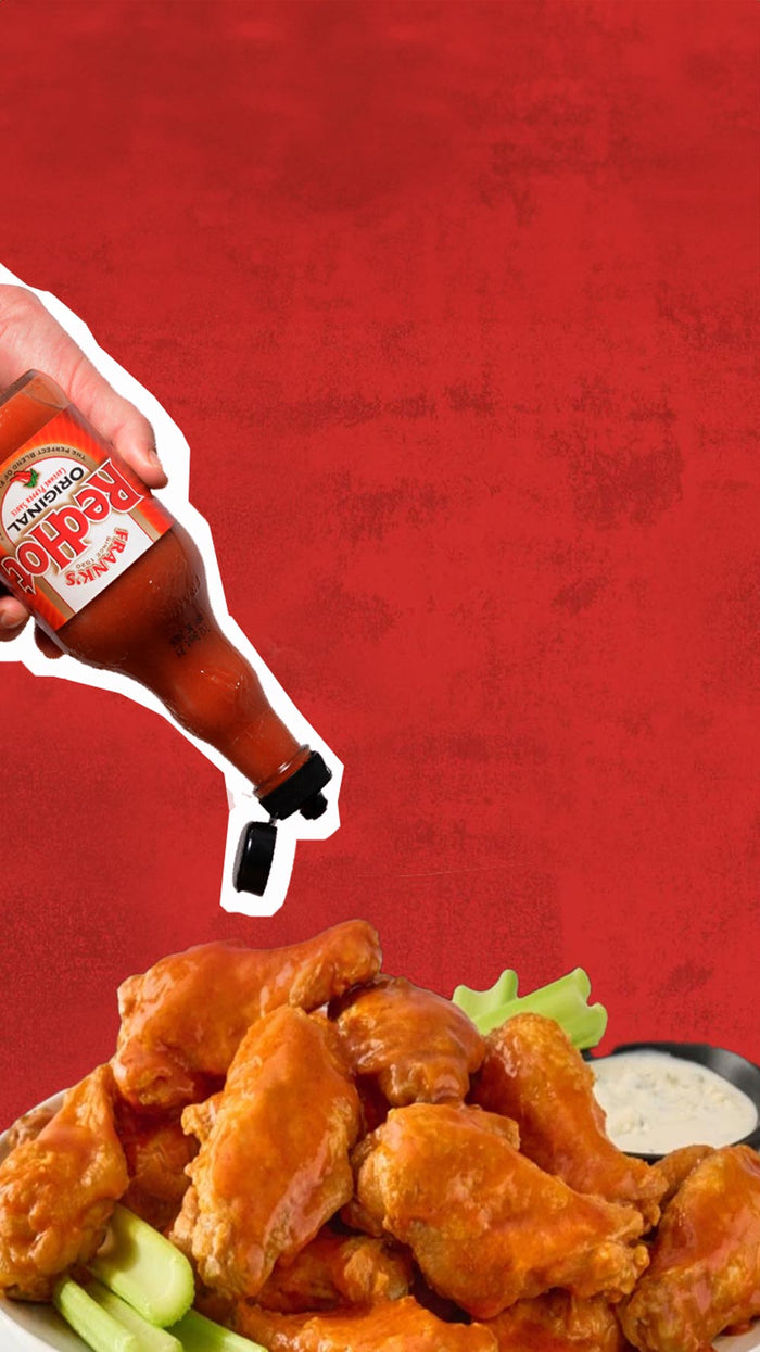 Franks redhot sauce pouring on wings