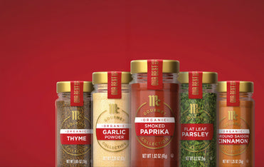 lineup of mccormick gourmet products organic thyme, organic garlic powder, organic smoked paprika, flat leaf parsley, and organic ground saigon cinnamon
