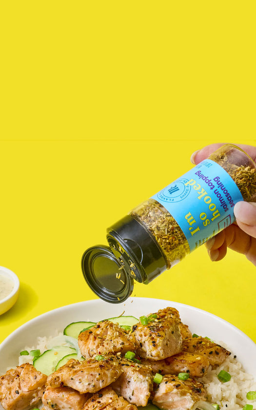 McCormick I'm So Hooked Salmon Topping being sprinkled on salmon and rice