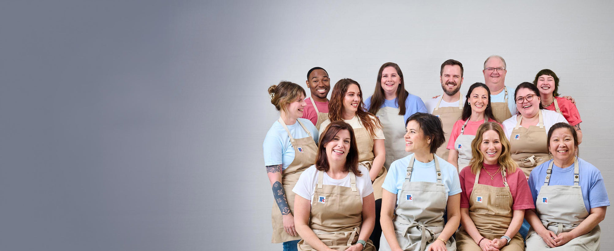 mccormick chefs sitting with aprons smiling at eachother