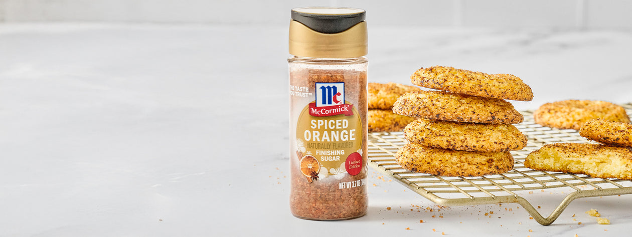 McCormick Spiced Orange Finishing Sugar next to a stack of spiced cookies cooling on a wire rack