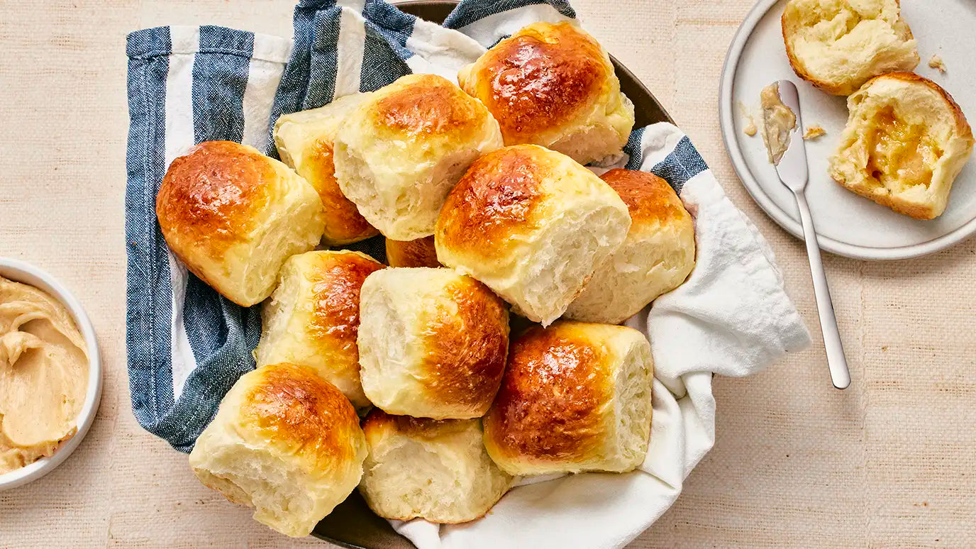 Bread basket with homemade dinner rolls and honey butter