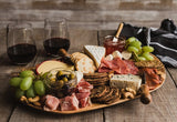 charcuterie board with two wine glasses
