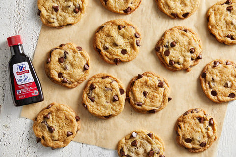 vanilla rich chocolate chip cookies with bottle of vanilla extract
