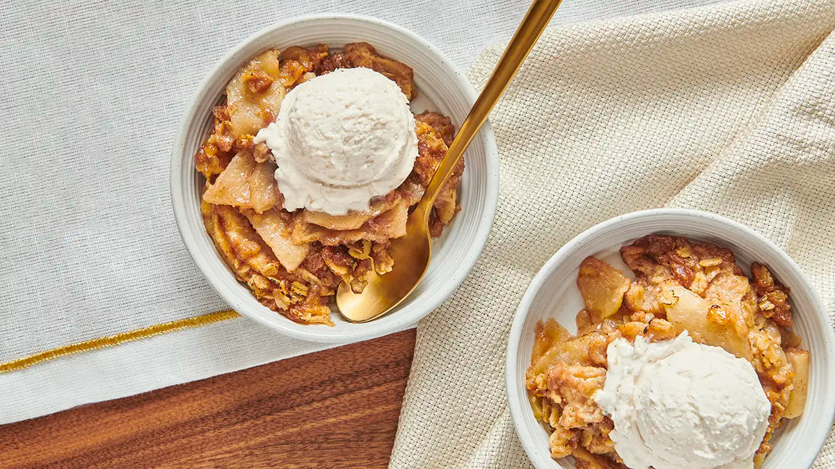 2 bowls of apple crisp served with ice cream