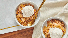 2 bowls of apple crisp served with ice cream