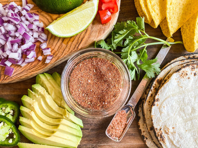 homemade taco seasoning surrounded by taco ingredients 