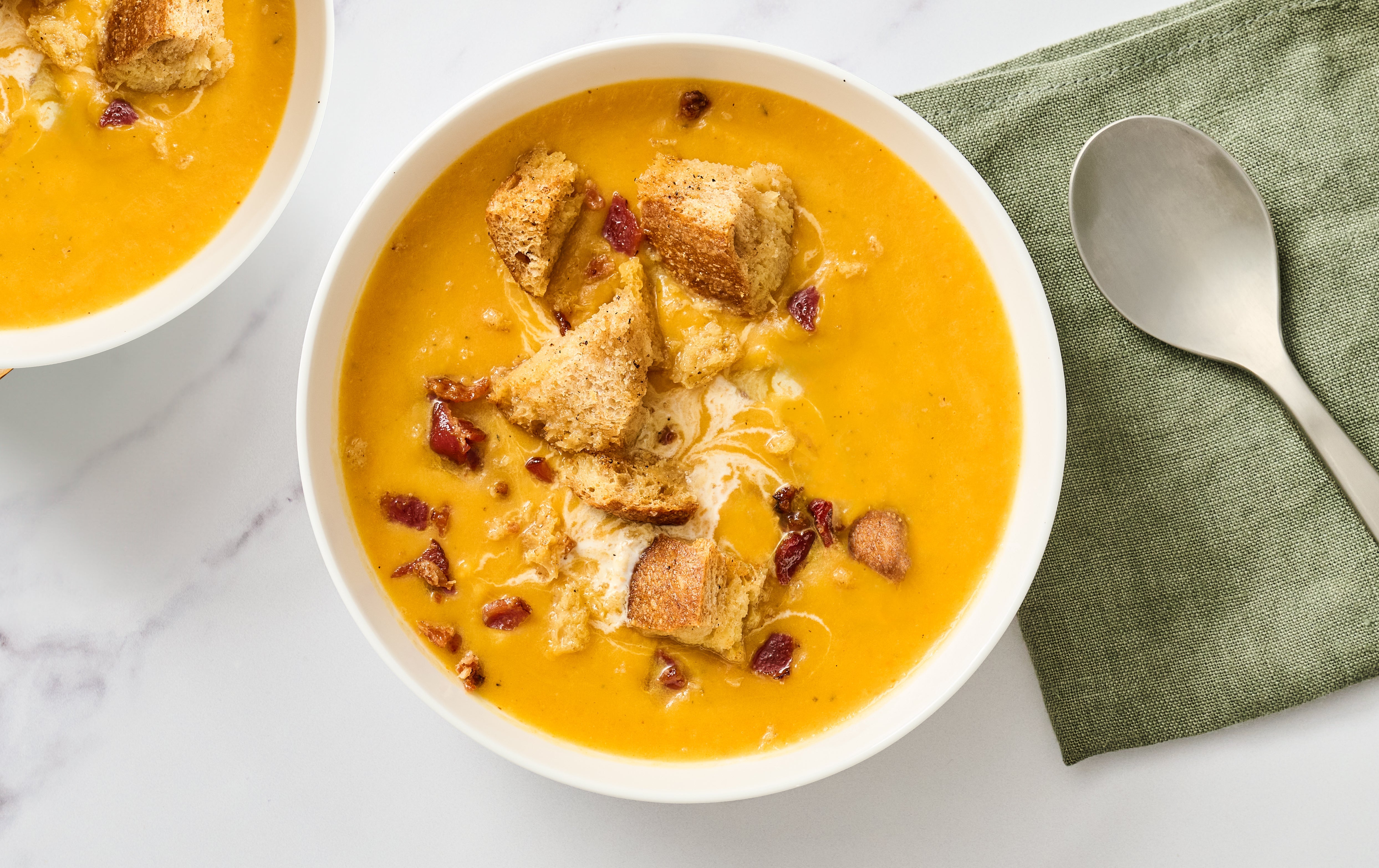 bowl of acorn squash soup topped with croutons