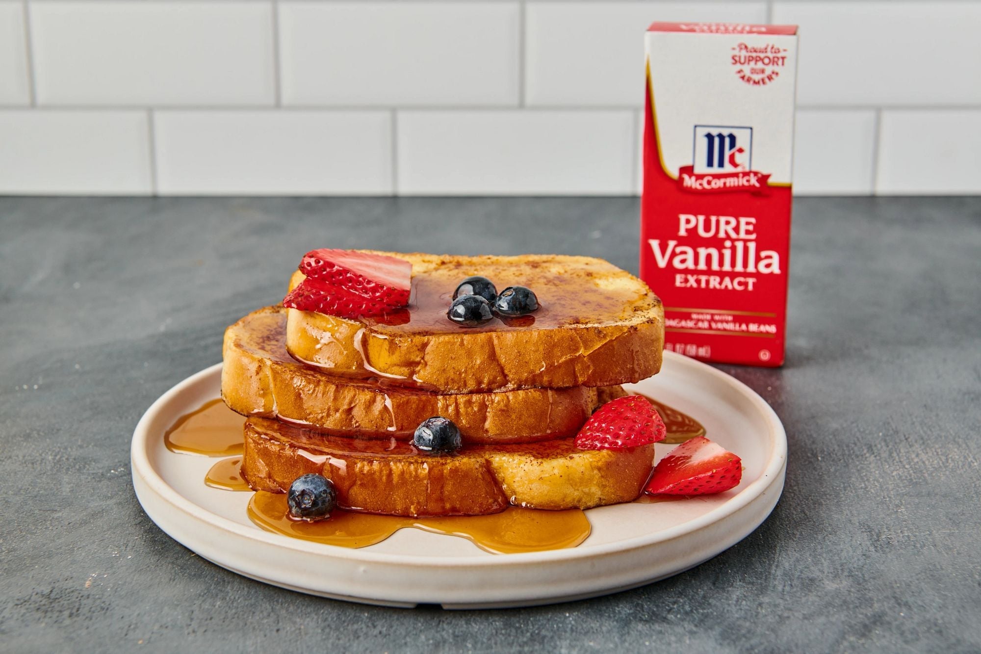 plate of quick and easy french toast with box of pure vanilla extract in background