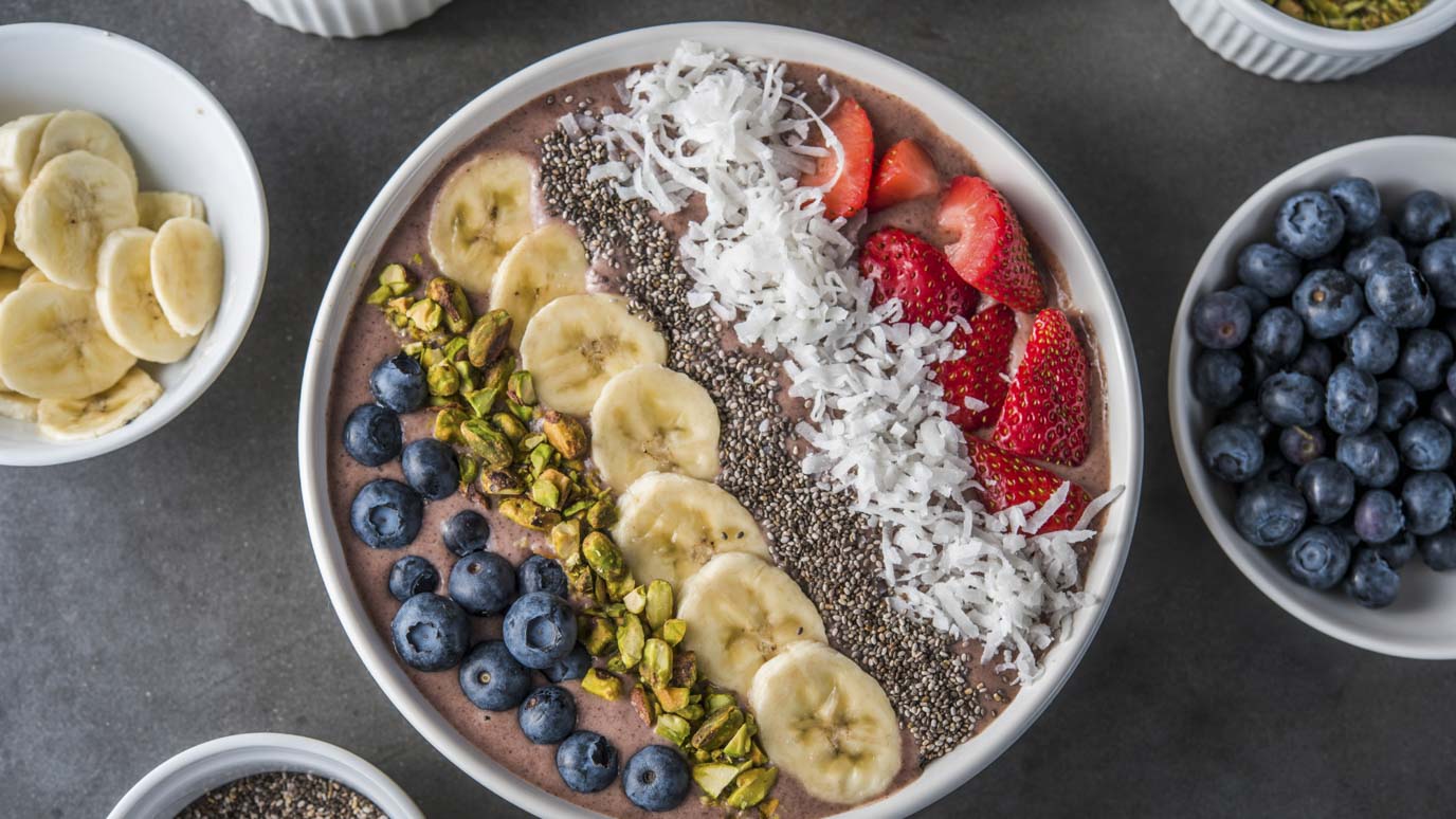 tropical acai smoothie bowl with various toppings