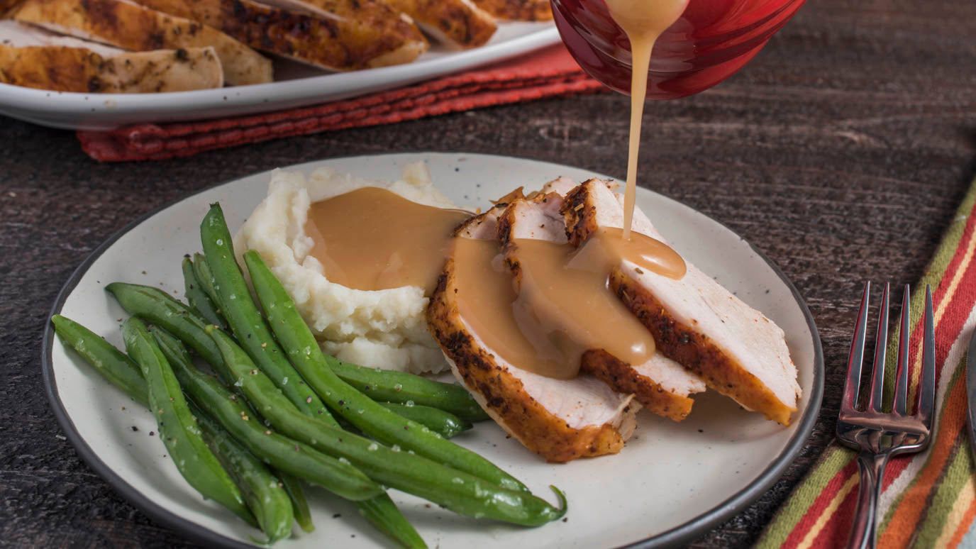 Perfect turkey gravy over turkey, mashed potatoes and green beans