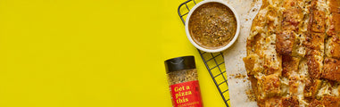 flavor maker seasoning topper, next to a dish on a yellow background
