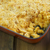 ['A close-up of a casserole dish filled with macaroni and cheese topped with breadcrumbs.']