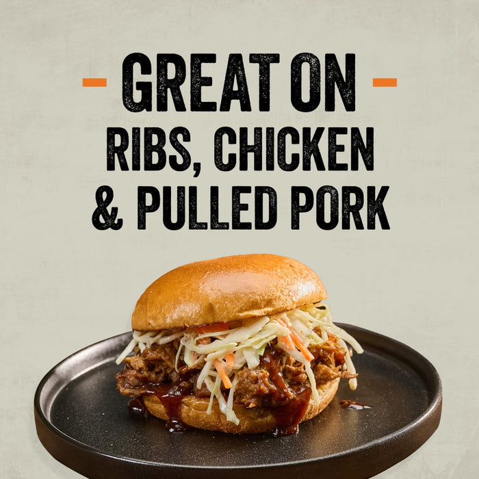 A pulled pork sandwich with coleslaw and barbecue sauce on a dark plate, illustrating the versatility of Mission Bbq Memphis Belle 15.5 Oz which is great on ribs, chicken, and pulled pork.