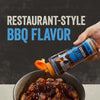 A hand pours Mission Bbq Blue Ridge Smoky Mountain 15 Oz BBQ sauce from its bottle onto grilled chicken pieces in a bowl, highlighting the restaurant-style BBQ flavor.
