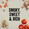The smoky, sweet, and rich flavor profile of Mission Bbq Blue Ridge Smoky Mountain 15 Oz is illustrated with chili peppers, wood chips, brown sugar, and tomatoes.
