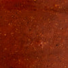 A close-up texture shot of Mission Bbq Texas Twang Bold Barbecue Sauce Plastic Squeeze Bottle 14.5 Oz, showing the rich red color and specks of spices.