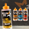 A bottle of Mission Bbq Kc Classic Bold Barbecue Sauce Plastic Squeeze Bottle 16 Oz is featured in the foreground, with three other barbecue sauce varieties from the same brand arranged behind it on a dark, textured background.