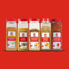 A collection of McCormick spice containers with red lids are displayed against a red background.