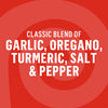 The image displays a red background with white text listing the classic blend of garlic, oregano, turmeric, salt, and pepper.