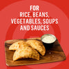 This image promotes a versatile product suitable for rice, beans, vegetables, soups, and sauces, showcasing three golden-brown empanadas served with a creamy dipping sauce on a wooden board.