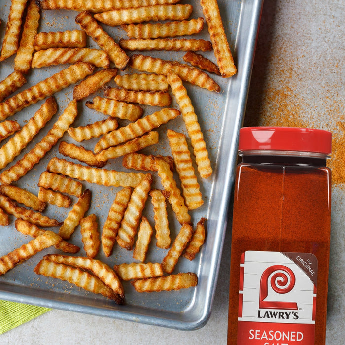 A tray of crinkle-cut fries is shown next to a container of Lawry's Seasoned Salt.