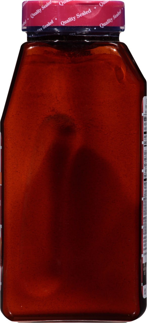 A brown glass bottle with a red lid that says Quality Sealed on it.