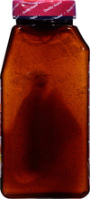 A glass bottle of McCormick Grill Mates Montreal Steak Seasoning.