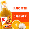 A bottle of Lawry\s Cuban Style Mojo Marinade is shown with the words Made With OJ &amp; Garlic next to a sliced orange and a bulb of garlic.