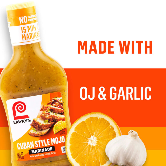A bottle of Lawry\s Cuban Style Mojo Marinade is shown with the words Made With OJ &amp; Garlic next to a sliced orange and a bulb of garlic.