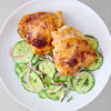 Crispy roasted chicken thighs are served over a refreshing cucumber and red onion salad, a delicious meal idea using Lawry'S Seasoning Salt &amp; Vinegar, 20 Oz.