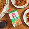 A box of Lawry's Sauce Marinara Mix is displayed next to a casserole dish and plates of baked ziti.