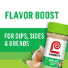 ["A jar of Lawry's Garlic Salt with a garlic clove and parsley in the foreground."]