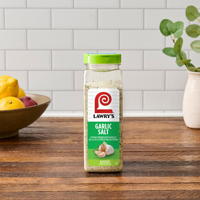 ["A jar of Lawry's Garlic Salt on a wooden table."]