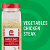 A container of Lawry's Garlic Salt seasoning, suggested for use on vegetables, chicken, and steak.