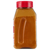 ['A glass jar with a red lid filled with a brown powder.']