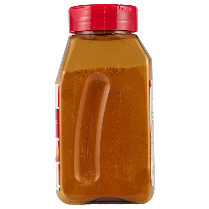 ['A glass jar with a red lid filled with a brown powder.']
