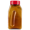 ['A bottle of honey with a red lid.']