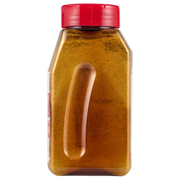 ['A bottle of honey with a red lid.']