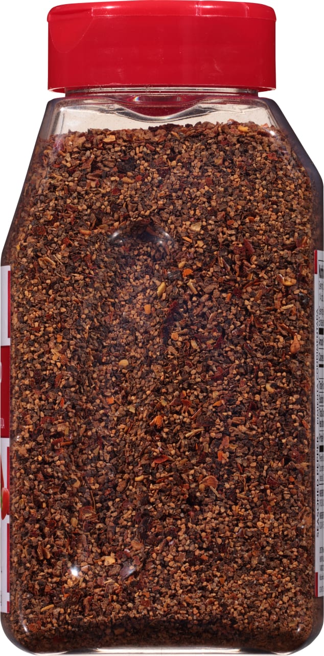 ['A glass jar of McCormick Black Pepper.']