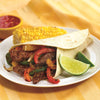 A delicious-looking beef fajita with corn on the cob and a side of salsa is presented on a white plate.
