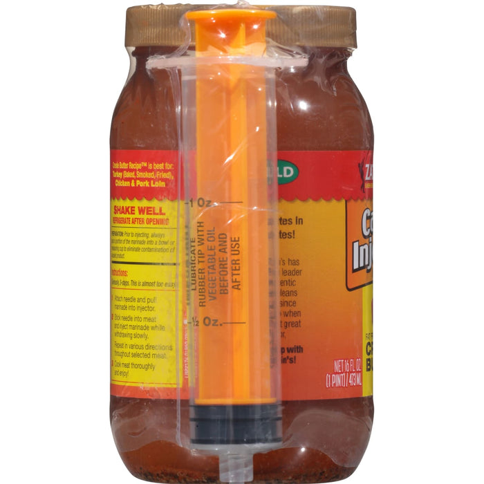 ["A bottle of Zatarain's Creole Butter Injection marinade with a syringe."]