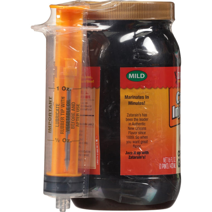["A bottle of Zatarain's Cajun Injector marinade with a small syringe for injecting the marinade into meat."]