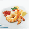 A plate of shrimp cocktail with cocktail sauce lemon wedges and parsley.